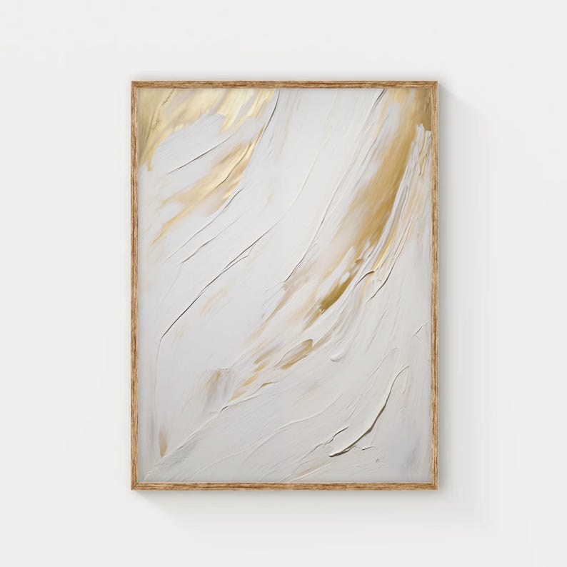 Printed abstract wall art in gold and white tones hanging in modern home interior.