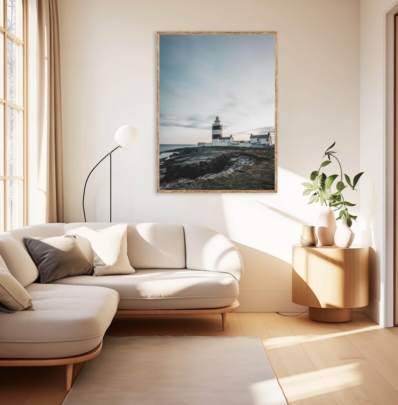 a living room with a white couch and a painting on the wall