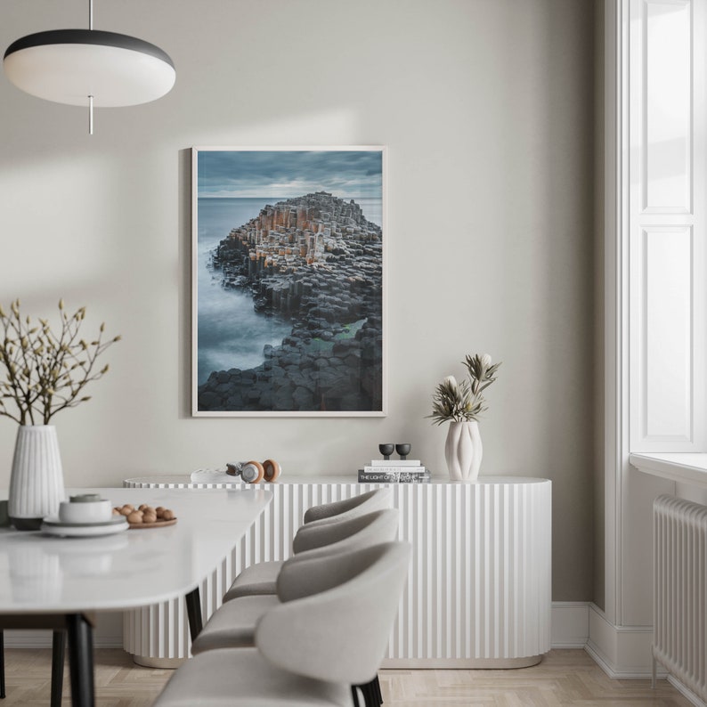 Framed coastal photo of The Giants Causeway against a white backdrop.
