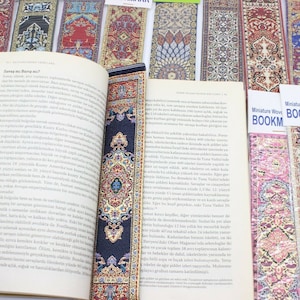 May include: A set of colorful woven bookmarks featuring intricate patterns inspired by traditional Turkish carpets. The bookmarks are labeled "Miniature Woven Carpet Bookmark".
