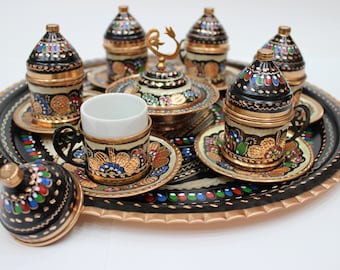 May include: A traditional Turkish coffee set with a tray, cups, saucers, and a sugar bowl. The set is decorated with intricate hand-painted floral designs in vibrant colors, including red, blue, green, and gold.