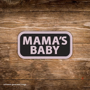 May include: A white ceramic mug with a black handle and the text "But First, Coffee" in a bold, black font. The mug is set against a blurred background, suggesting a cozy setting.