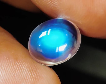 May include: A blue oval-shaped gemstone with a iridescent sheen.
