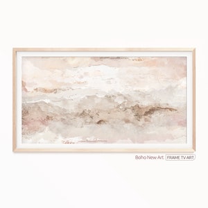 May include: Abstract watercolor painting in shades of pink, brown, and white. The painting is framed in a light wood frame. The text "Boho New Art" is below the frame.