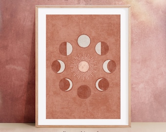 May include: A framed print with a boho aesthetic featuring a sun and moon phases design in shades of brown, white, and beige. The background is a textured, terracotta color. The text "Boho New Art" and "Emel Tunaboylu" is at the bottom of the print.