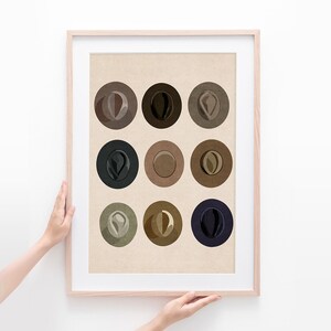 May include: A framed print with nine circles, each containing a different color and shade of brown, black, and blue. The circles are arranged in a 3x3 grid.