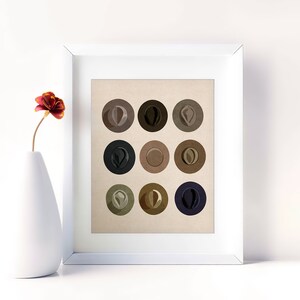 May include: A framed print of nine different colored hats, each in a circle on a beige background. The hats are in shades of brown, black, and gray.