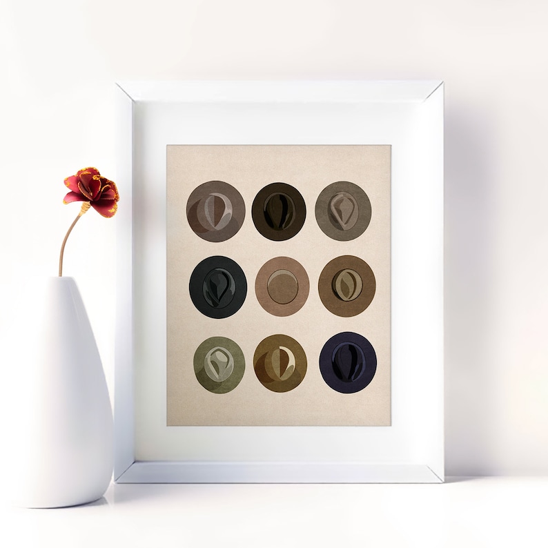 May include: A framed print of nine different colored hats, each in a circle on a beige background. The hats are in shades of brown, black, and gray.