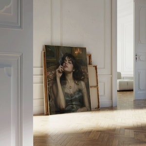 May include: A painting of a woman with dark hair and a dark dress, she is holding a cigarette and looking down. The painting is framed in gold and has a dark background.