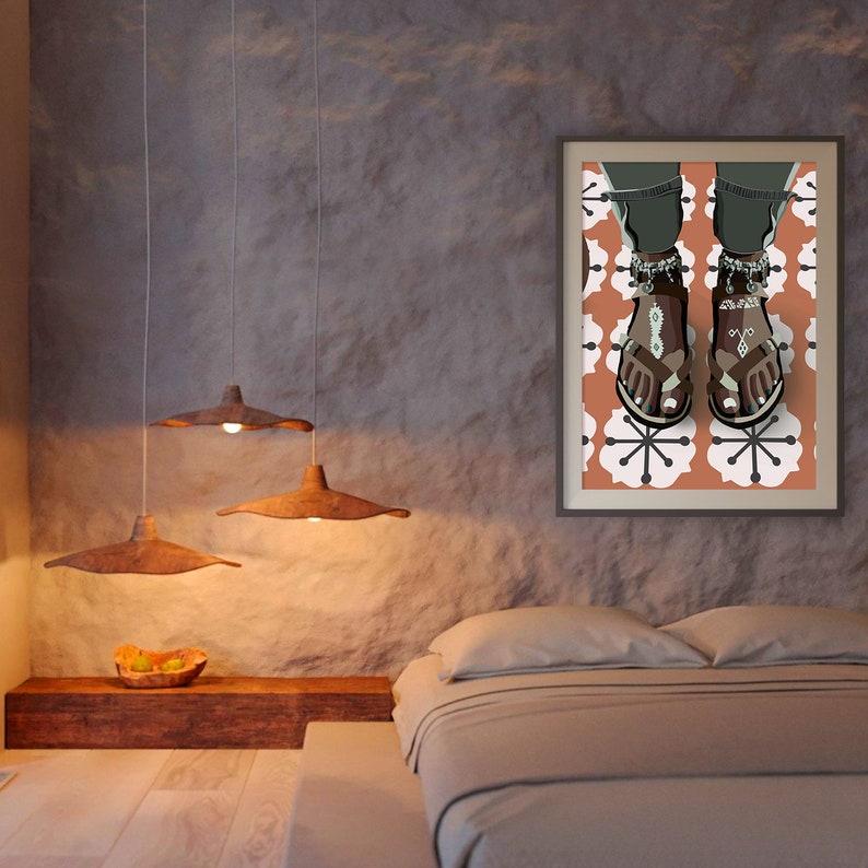 May include: A framed art print featuring an illustration of sandals with decorative anklets. The sandals are brown and white, set against a floral pattern in orange and white. The artwork is displayed in a bedroom setting with pendant lights.