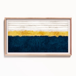May include: Abstract art print in a wooden frame. The print features a horizontal stripe pattern in white, gold, and dark blue.