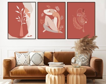 Op de afbeelding: Drie minimalistische kunstprints met een rode achtergrond en witte lijntekeningen. De prints tonen een vaas met een plant, een zittend figuur en het gezicht van een vrouw.