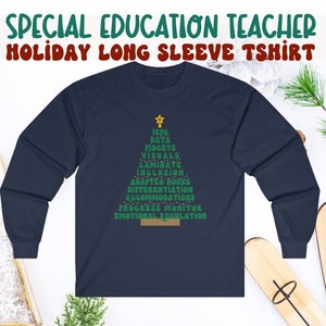 May include: A navy blue long-sleeve t-shirt with a green Christmas tree design. The tree is made up of words related to special education, including "IEPs", "data", "fidgets", "visuals", "laminate", "inclusion", "adapted books", "differentiation", "accommodations", "progress monitor", and "emotional regulation".