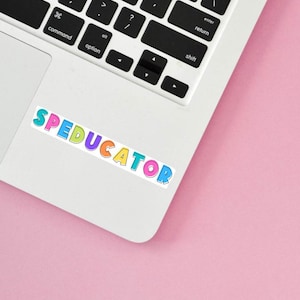 May include: A colorful sticker with the word "SPEDUCATOR" on a white laptop.