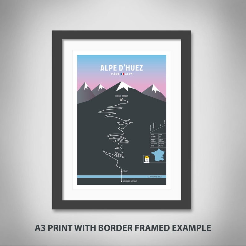 May include: A framed print of a black and white illustration of the Alpe d'Huez mountain pass in France. The illustration shows the winding road up the mountain, with elevation markers and a map of France in the bottom right corner. The title "Alpe d'Huez Isere Alps" is at the top of the print.