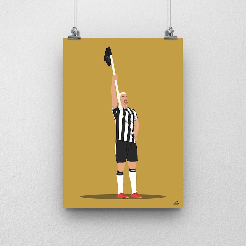 May include: A black and white striped soccer jersey with a white collar and black trim. The jersey is being held up in the air by a person wearing red shoes. The background is a solid gold color.