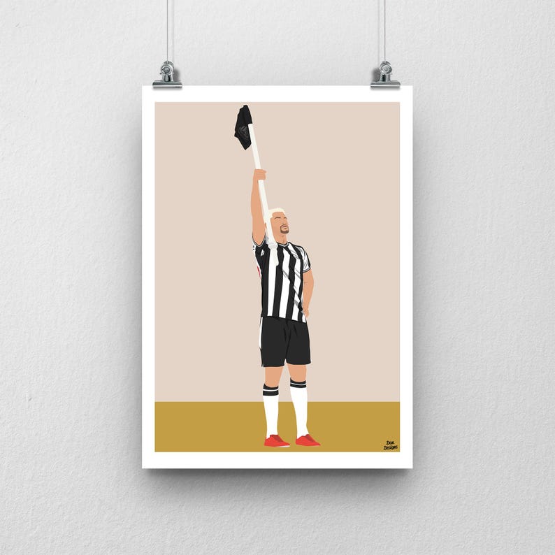 May include: A black and white striped soccer jersey with a player holding a black jersey above their head. The player is wearing red shoes and has blonde hair.