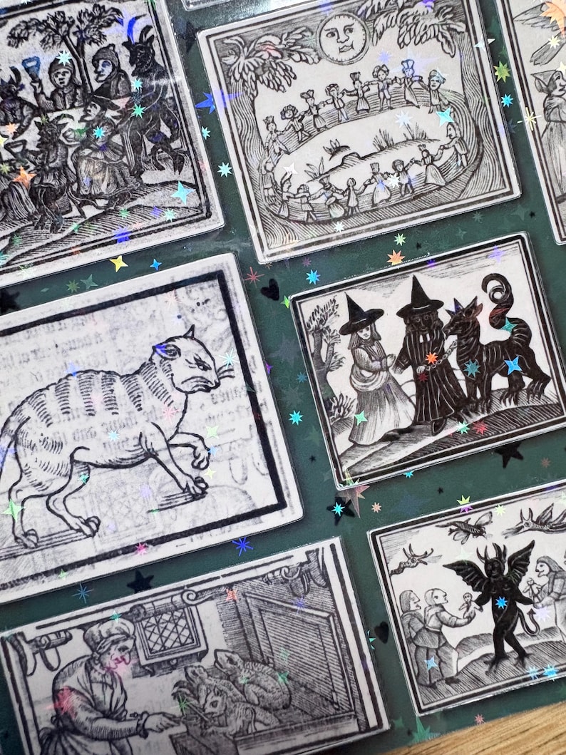 May include: A sticker sheet featuring multiple rectangular black and white illustrations with a holographic star overlay. The designs depict various scenes including a cat, figures in a circle, a person with a horned creature, and a winged demon.