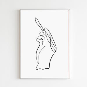 May include: A black and white line drawing of a hand holding a pen or pencil.