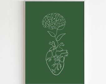 Puede incluir: Una impresión artística enmarcada con un dibujo lineal blanco de un corazón y un cerebro conectados por un tallo y hojas. La obra de arte está sobre un fondo verde oscuro.