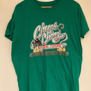 May include: Green t-shirt featuring a graphic of Cheech & Chong and the text "Rolling Papers" with the website www.cheechandchongpapers.com.