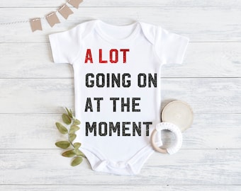 Alot Going on at the moment 1sies for babies with REAL red and black glittered printing, swift inspired Tay concert shirt for family