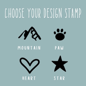 May include: Four black and white design options for a stamp: a mountain, a paw print, a heart, and a star. The text below each design reads "Mountain", "Paw", "Heart", and "Star".