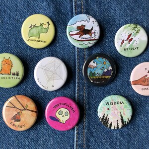 May include: Ten round, colorful buttons with different illustrations and text. The buttons feature themes such as loving-kindness, patience, generosity, wisdom, and truthfulness.