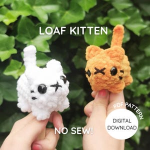 May include: Two small crocheted kitten figures, one white and one orange, with black plastic eyes and stitched facial features. The text LOAF KITTEN, NO SEW!, and PDF PATTERN DIGITAL DOWNLOAD are visible on the image of these plush toys.
