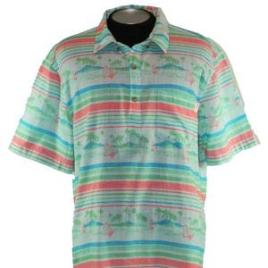 Pu&ograve; includere: Polo a maniche corte con un design tropicale. La camicia presenta strisce orizzontali nei toni dell'azzurro, del verde e del corallo. Il motivo include piccoli motivi di isole e palme. Ha un colletto abbottonato e una vestibilit&agrave; rilassata.