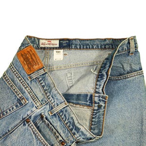 May include: Light blue denim jeans with a brown leather Levi Strauss & Co. label and a blue Levi's label that reads "Relaxed Fit 567".