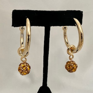 Made in USA&quot;Vintage gold earrings with topaz crystal ball dangle.Designed by Norma Jean worn by Selina