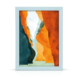 May include: Abstract watercolour painting of a canyon with orange, yellow, and blue hues. The painting is framed in a light blue frame.