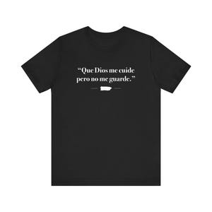 May include: Black t-shirt with the text "Que Dios me cuide pero no me guarde." in white. The shirt also features a white outline of Puerto Rico. The t-shirt is made of a soft, comfortable material.