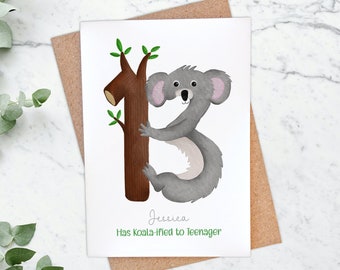 May include: A birthday card featuring a cartoon koala holding onto a tree branch. The card says "Jessica Has Koala-fied to Teenager".