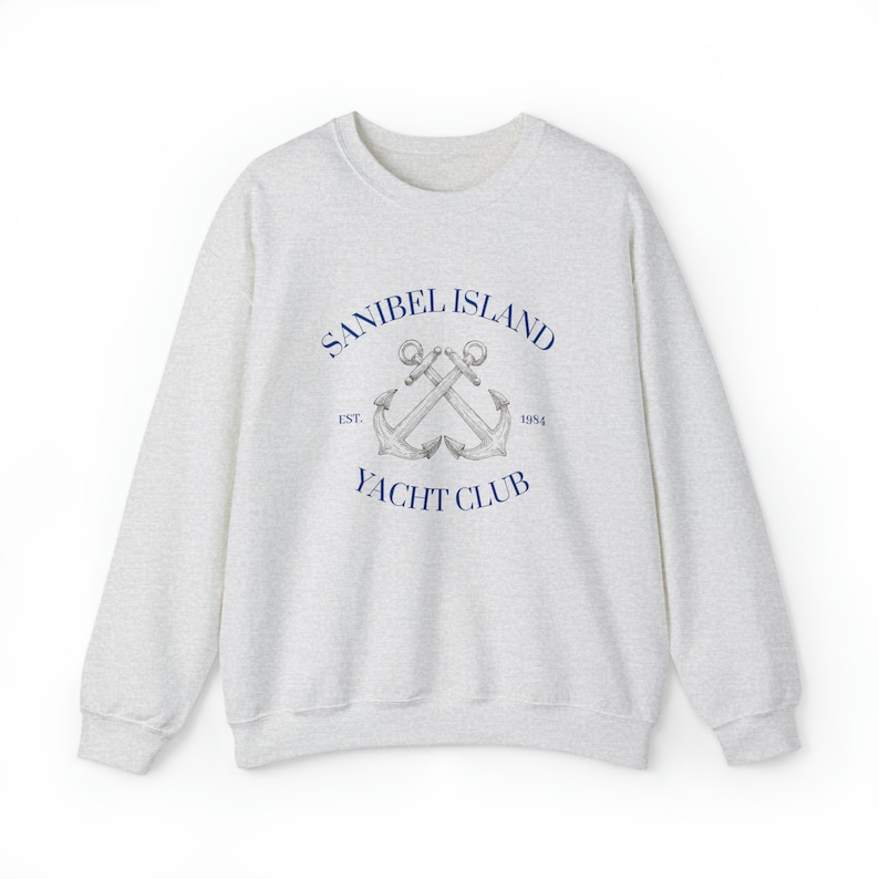 May include: A heather gray sweatshirt with a navy blue logo that says "Sanibel Island Yacht Club" with two crossed anchors and the text "Est. 1954".