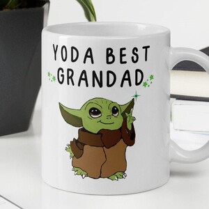 May include: White ceramic mug with a green cartoon character and the text "Yoda Best Grandad" in black.