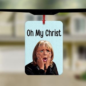 May include: A white car air freshener with a blue background and a picture of a woman with a surprised expression. The text "Oh My Christ" is printed in black at the top of the air freshener.