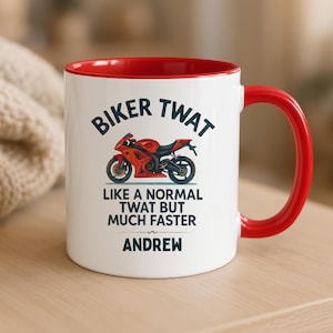 May include: White ceramic mug with a red interior and handle. The mug features the text "BIKER TWAT" above a red motorcycle graphic, with the phrase "LIKE A NORMAL TWAT BUT MUCH FASTER" and the name "ANDREW" below.