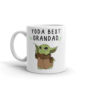 May include: White ceramic mug with a green cartoon character and the text "YODA BEST GRANDAD" in black.