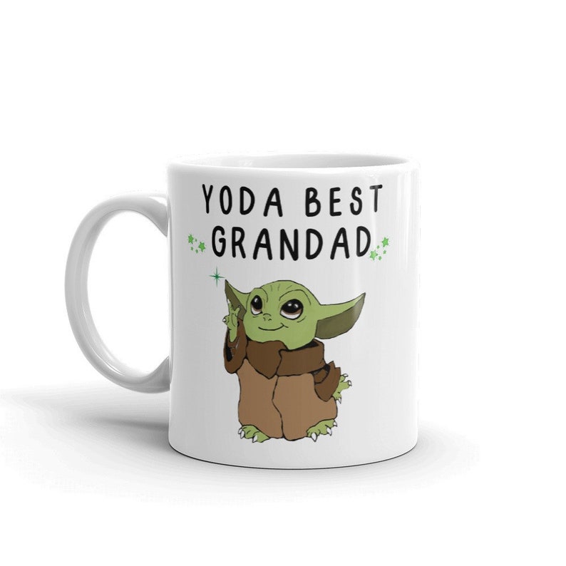 May include: White ceramic mug with a green cartoon character and the text "YODA BEST GRANDAD" in black.