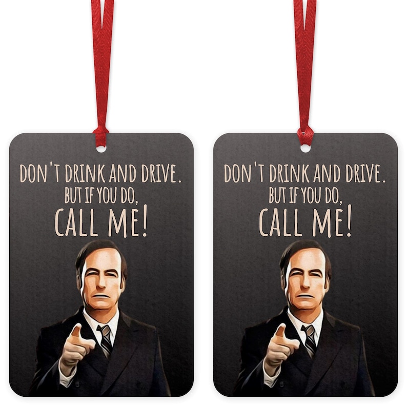 May include: Two black rectangular car air fresheners with a white background and a picture of a man in a suit. The text on the air fresheners reads "Don't drink and drive. But if you do, call me!"