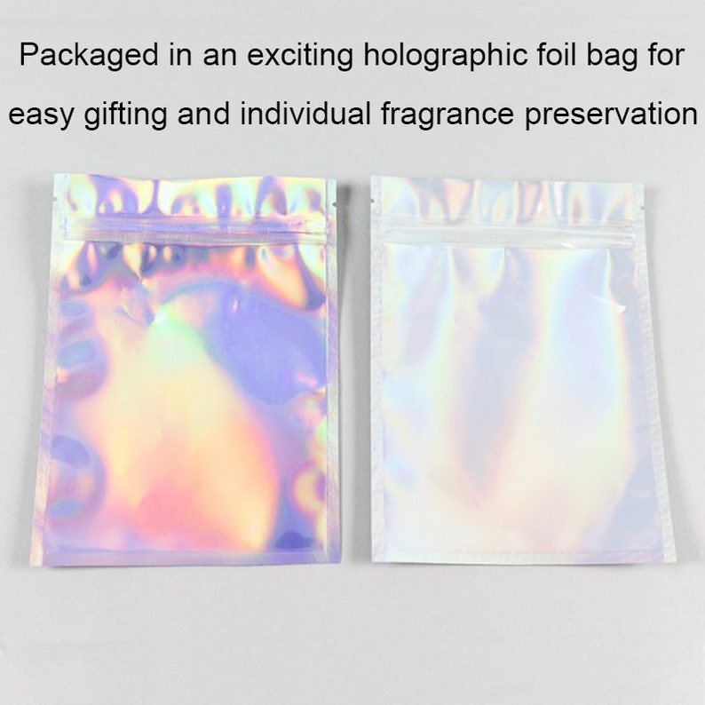 May include: Two iridescent holographic foil bags with zipper closures. The bag on the left has a rainbow iridescent finish. The bag on the right is a plain iridescent finish.