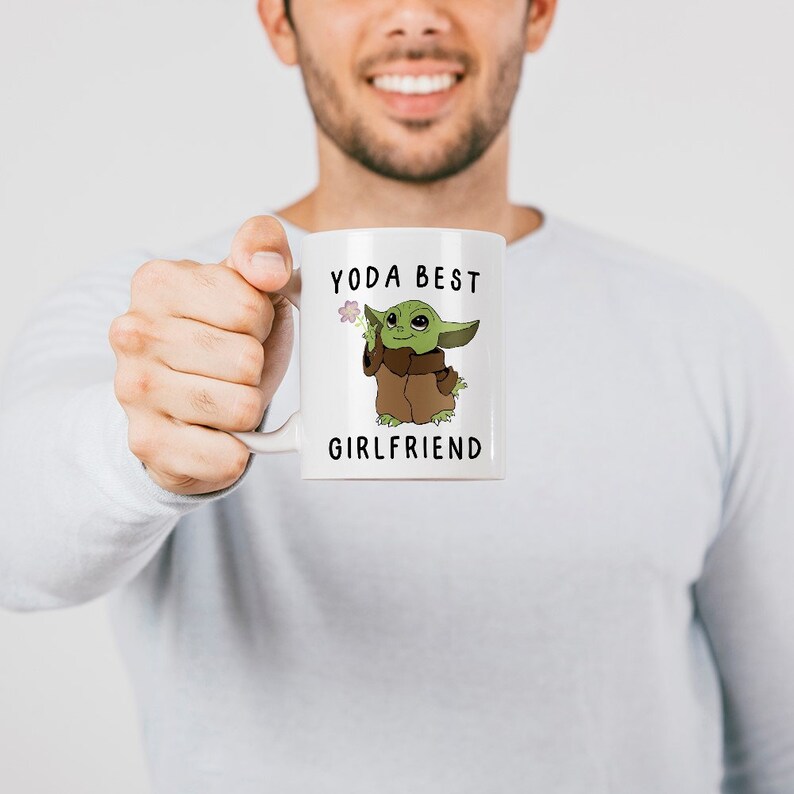 May include: White ceramic mug with a green cartoon character holding a flower and the text "Yoda Best Girlfriend".