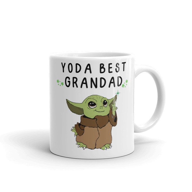 May include: White ceramic mug with a green cartoon character and the text "YODA BEST GRANDAD" in black.