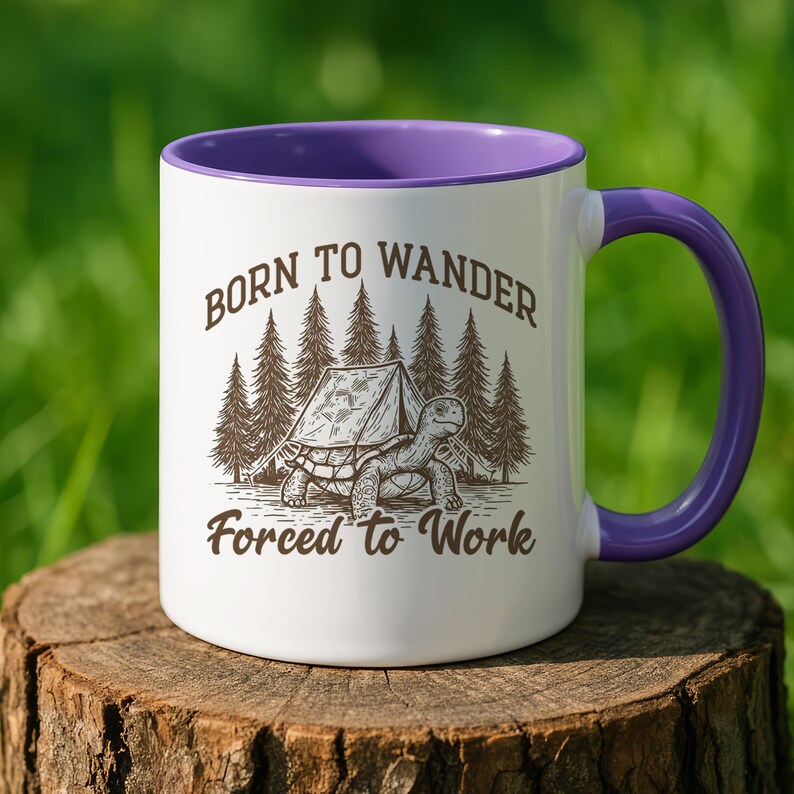 May include: White ceramic mug with a purple interior and handle. The mug features a graphic of a turtle with a tent in front of a forest, and the text "Born to Wander Forced to Work."