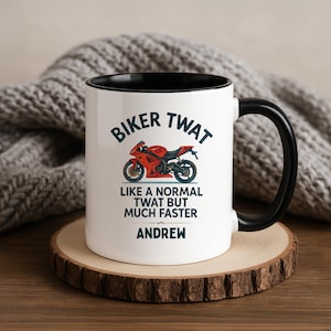 May include: White ceramic mug with a black interior and handle. The mug features the text "BIKER TWAT" above a red motorcycle graphic. Below the graphic is the text "LIKE A NORMAL TWAT BUT MUCH FASTER" and the name "ANDREW".