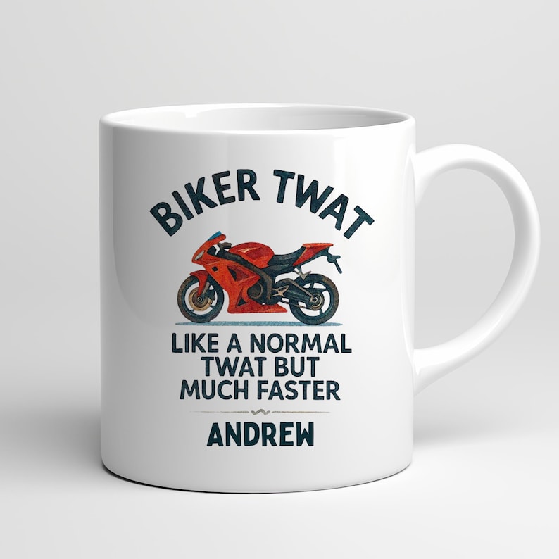 May include: White ceramic mug with the text "BIKER TWAT" above a red and black motorcycle graphic. Below the graphic, the mug reads "LIKE A NORMAL TWAT BUT MUCH FASTER" and the name "ANDREW".