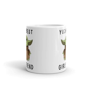 May include: White ceramic mug with a green and brown cartoon character on each side. The text "Best Friend" is on the left side and "Yoda Girl" is on the right side.