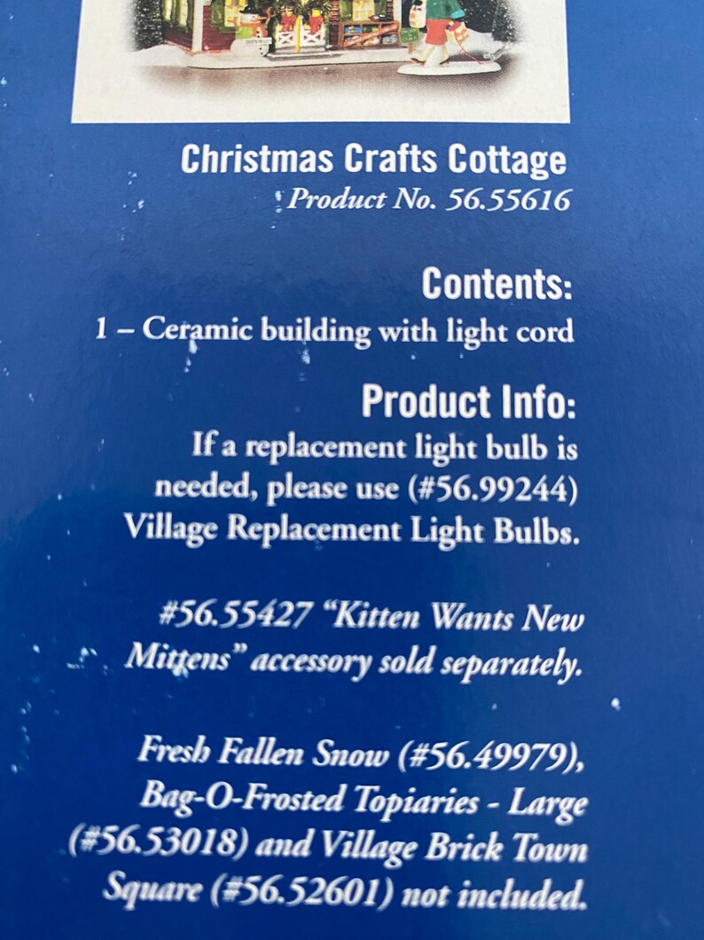 Może przedstawiać: Niebieskie pudełko produktu z tekstem "Christmas Crafts Cottage" i "Product No. 56.55616". Zawartość obejmuje ceramiczny budynek z przewodem świetlnym. Zawiera r&oacute;wnież dodatkowe informacje o produkcie.